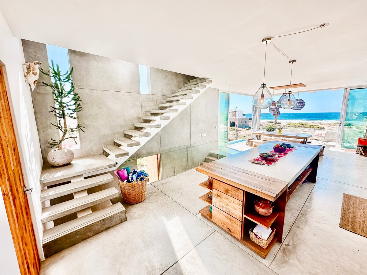 Floating concrete staircase beside the open kitchen