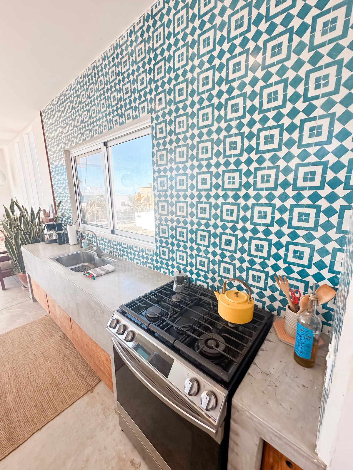 Kitchen range and sink against the blue-and-white tiled wall