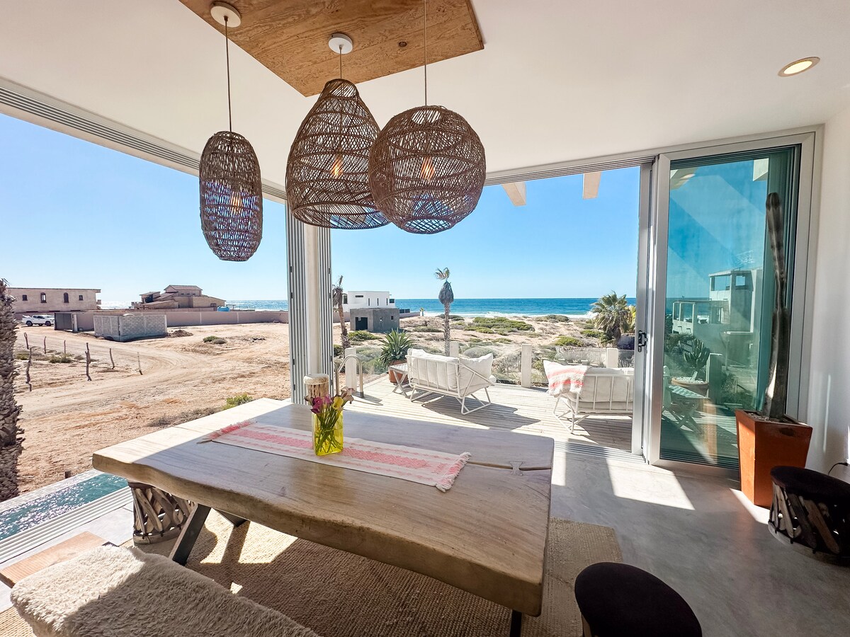 Dining table, pool deck and Pacific view from the open living room