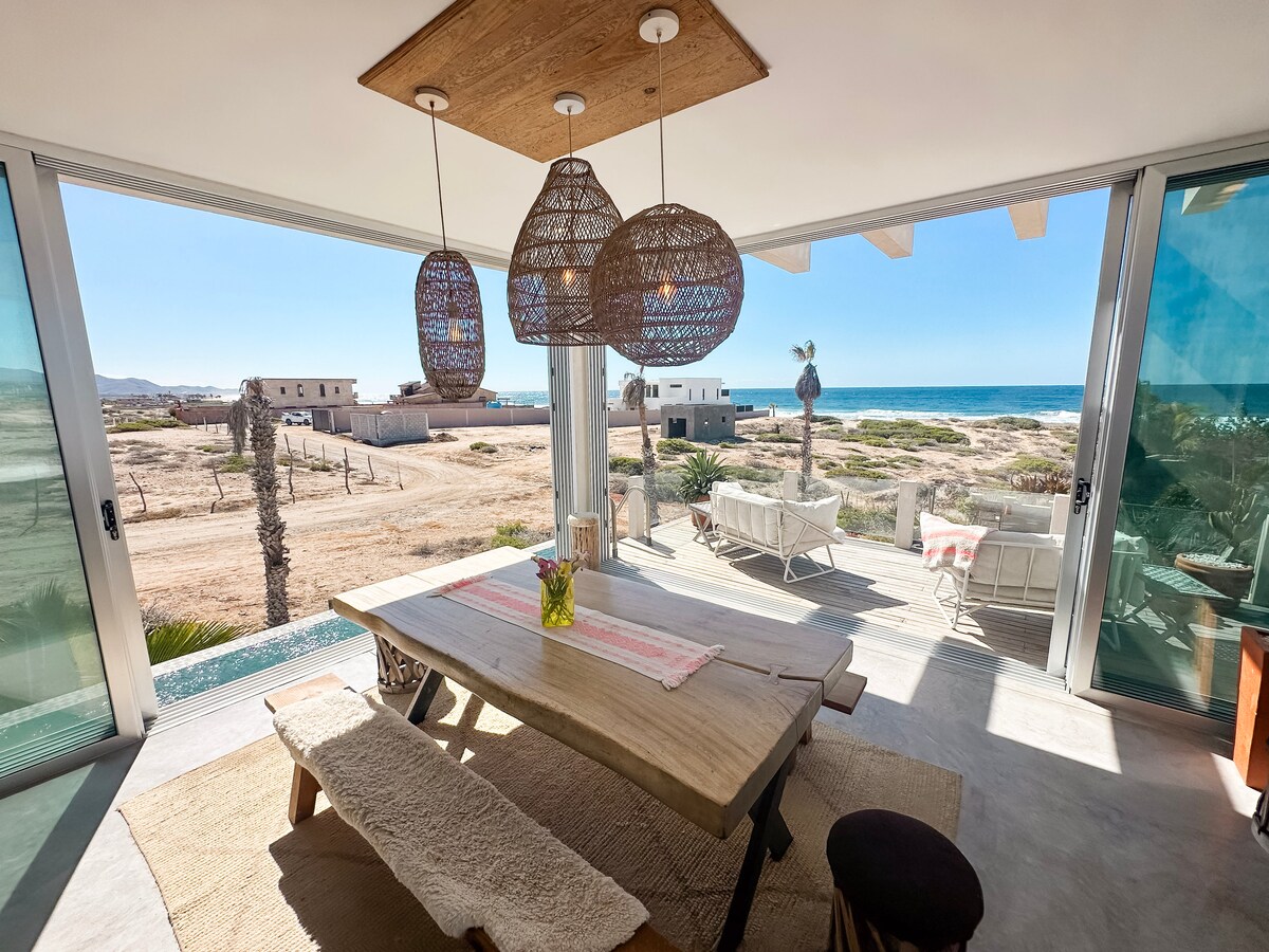 Open dining area and west-facing deck looking across coastal land to the Pacific