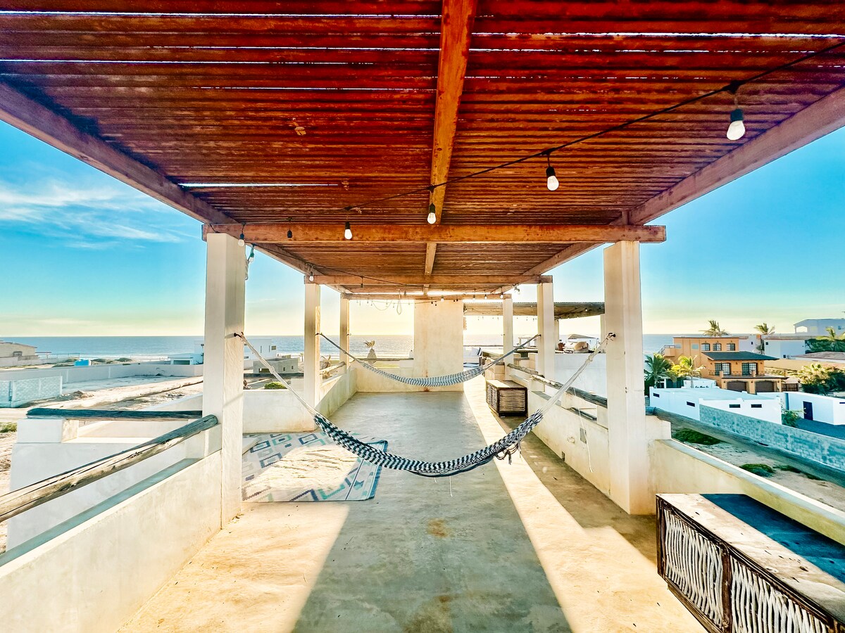 Hammocks beneath the shaded rooftop palapa